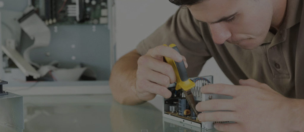A white male students builds a computer component in the lab
