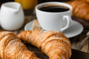 A breakfast selection including croissants and a hot cup of coffee