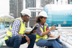 Person assembling an engineering circuit board using a screwdriver at a home workspace