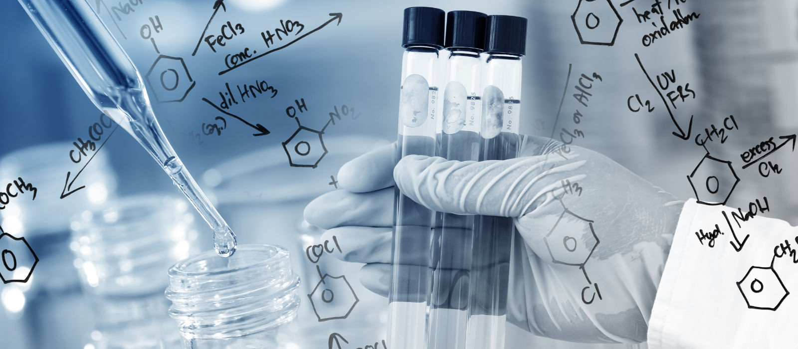 Beakers in the science lab and formulas written on a whiteboard
