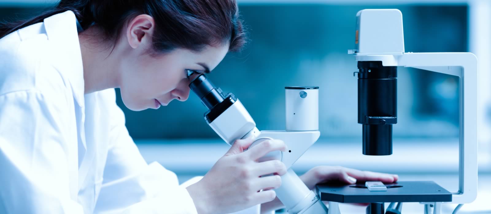 Scientist working in a lab using a microscope