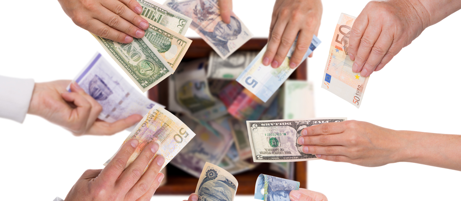 Hands holding paper money from different countries