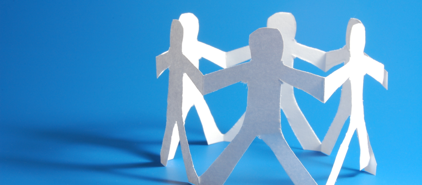 Paper cut outs of people in a circle