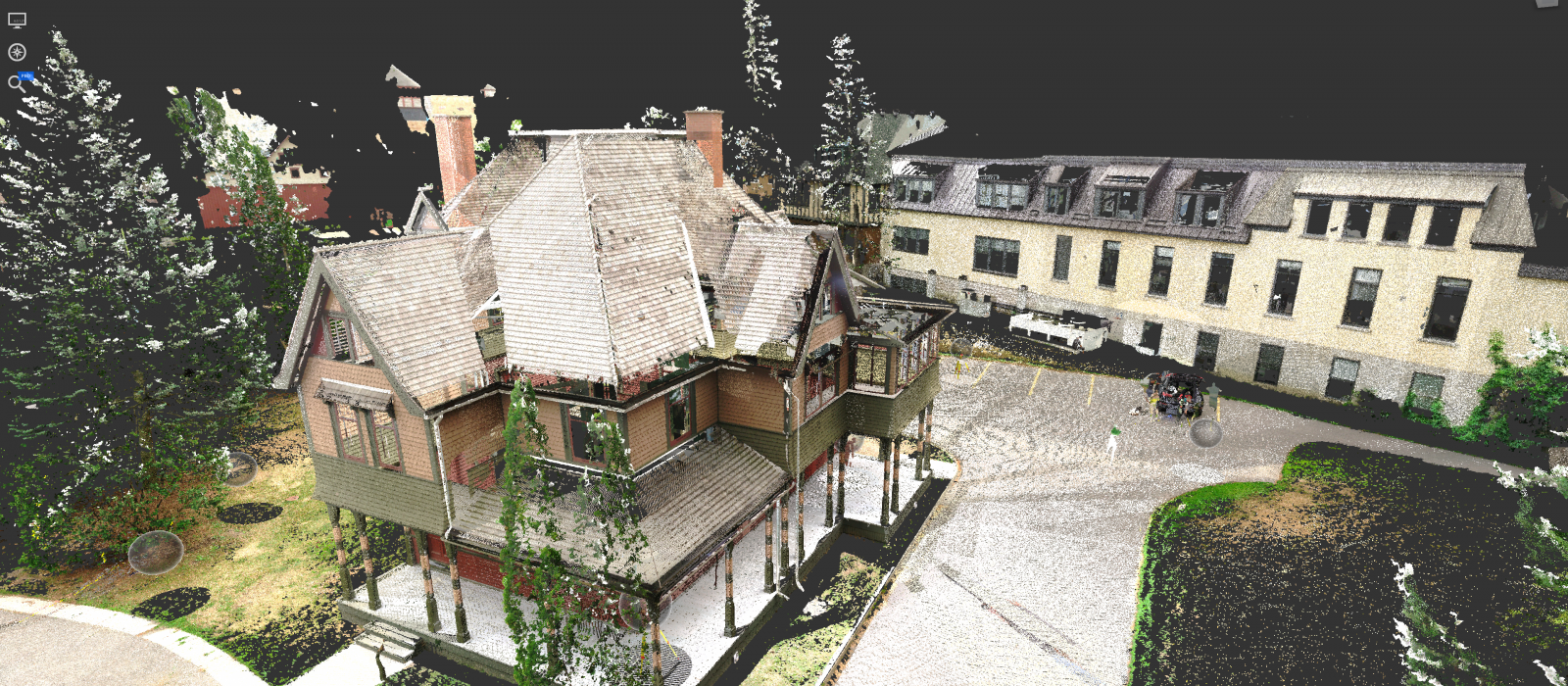 A detailed scale model of a detached century home, next to a row of modernized town homes.